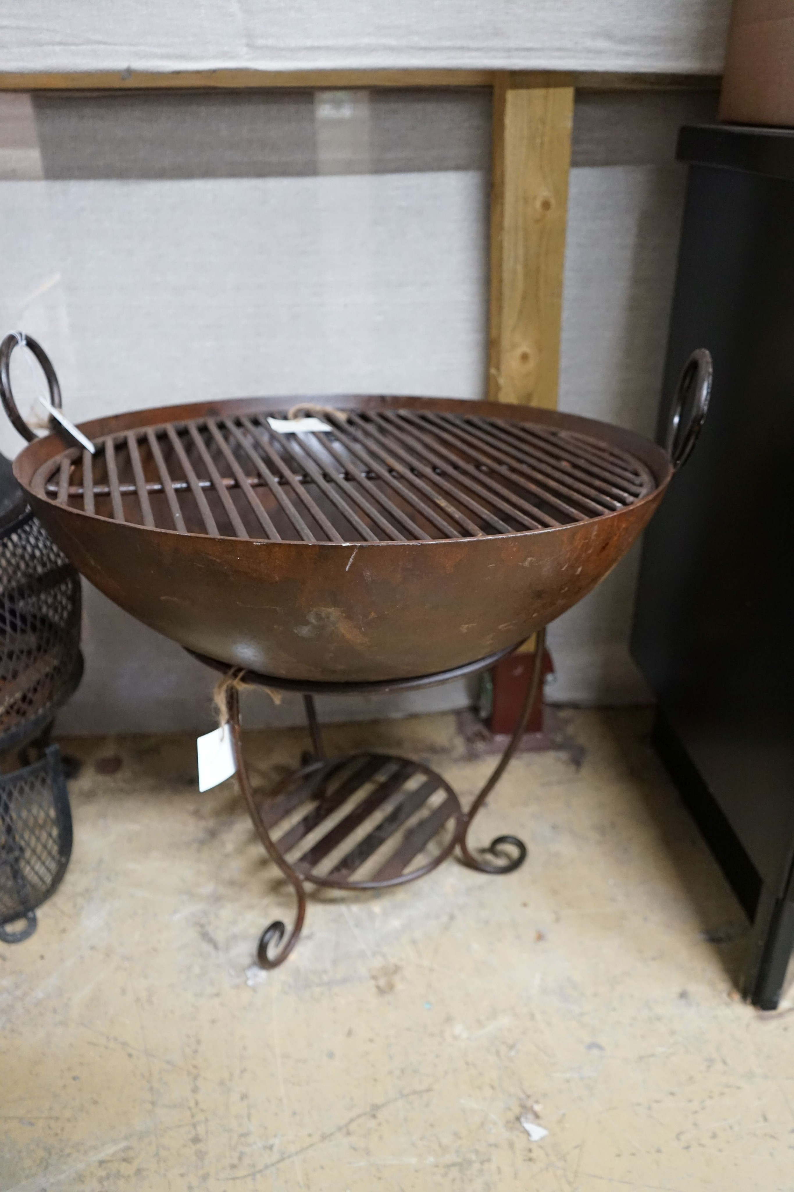 A circular wrought iron fire pit, diameter 62cm, height 67cm